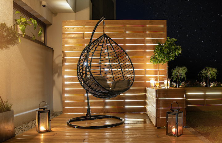 night-time-in-stylish-garden-with-wooden-porch-and-PBZLVJK